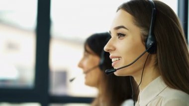 4k. Office çağrı merkezi çalışması. İki genç güzel kadın operatörler cevap müşteri 