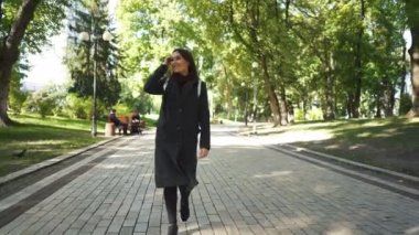   4k. Oldukça gülümseyen genç Asyalı kadın şehir parkı yürümek. Hayatın tadını Çıkarın Steady çekim