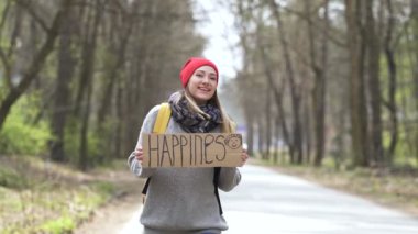 Poster mutluluk ile yolda gülümseyen otostop kız. Seyahat hayatı