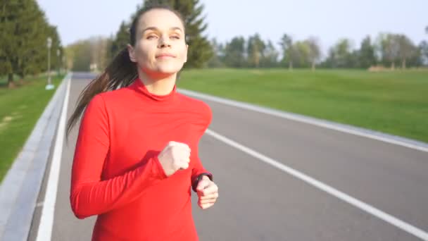 Woman Runner Run Empty Road Red Clothes Listen Music Earphones — Stock Video