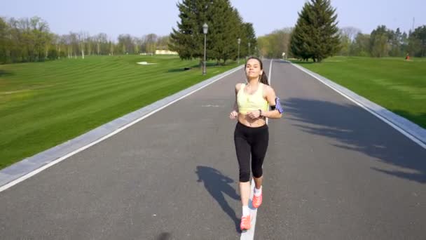 Woman Yellow Run Road Listen Music Earphones Steady Shot Sport — Stock Video