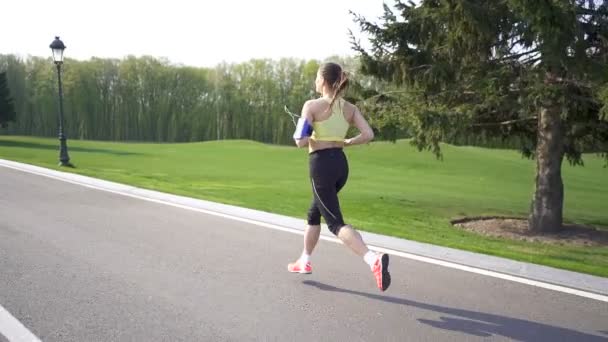 Corredora Corre Por Camino Vacío Mañana Cámara Lenta Vista Trasera — Vídeo de stock