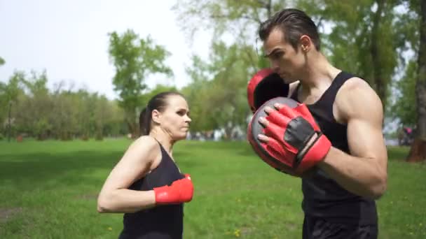 Мужчина Боксер Тренирует Женщину Боксерскими Лапами Спортивная Команда Городского Парка — стоковое видео