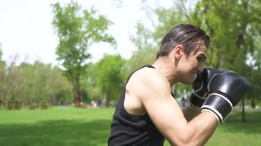 Yavaş hareket. Siyah eldiven genç kaslı adam Boxer darbeler yok. Sabit atış, lateral hareket 