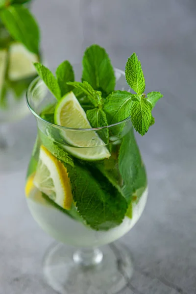 Mojito and Lemonade summer cold drink in a plastic glass with a straw.  Coctail with mint, lemon, lime and ice. Serve at the bar. Beverage closeup  Stock Photo - Alamy