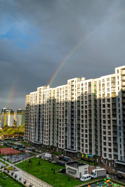 Rainbow over a high-rise building. Multi-apartment residential building. Housing area