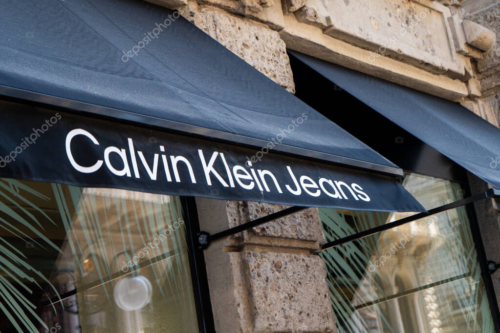 Calvin Klein Jeans Store in Milano logo brand sign. Official Shop entrance window. Italy, Milan - July 17, 2025