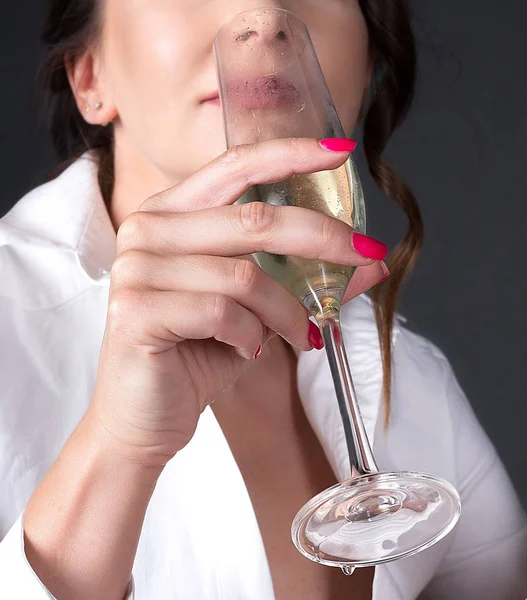 A glass of champagne in the woman hands. Romantic picture