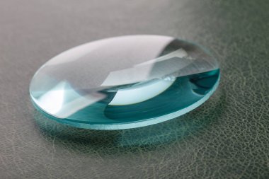 Optical convex lens, glass lens close up. clipart