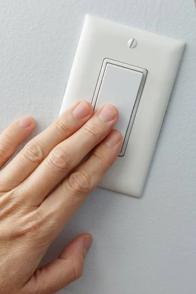 Hand Turning White Light Switch — Stock Photo, Image
