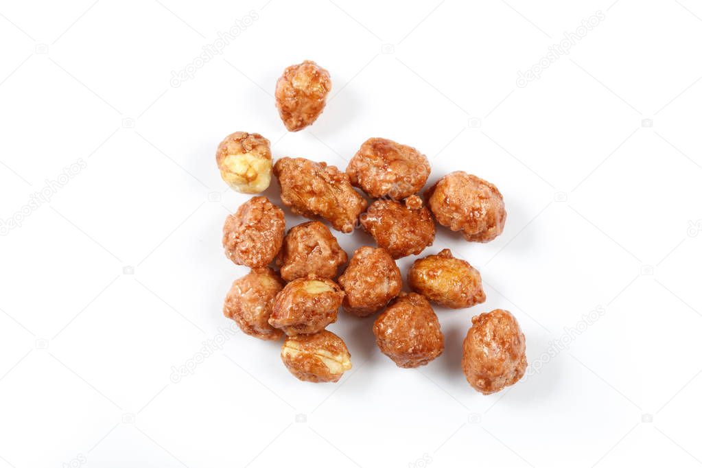 Roasted peanuts in icing sugar close up. 