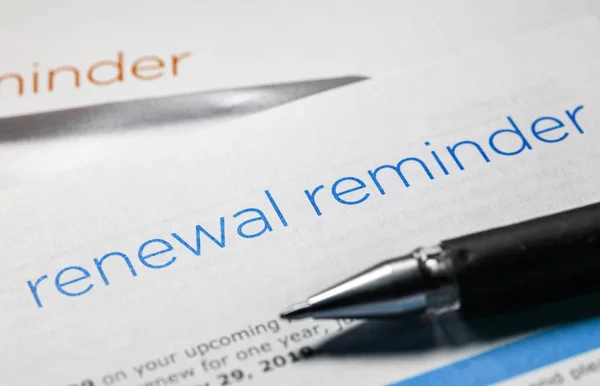 renewal reminder business letter and a pen