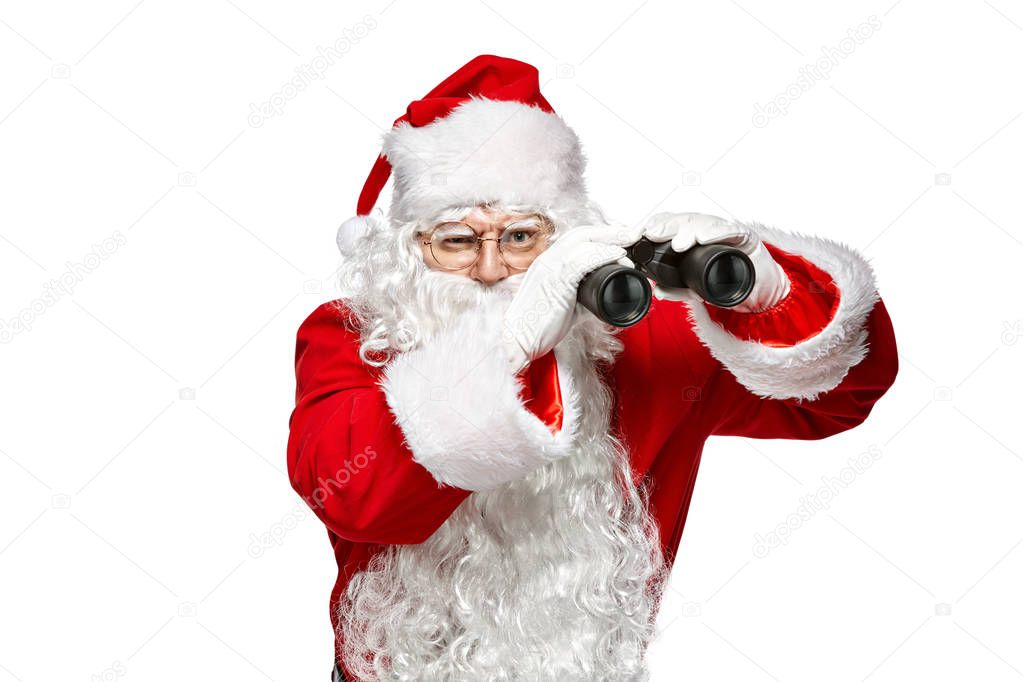 Santa Claus looking through binoculars. Isolate on white background.  Christmas concept.