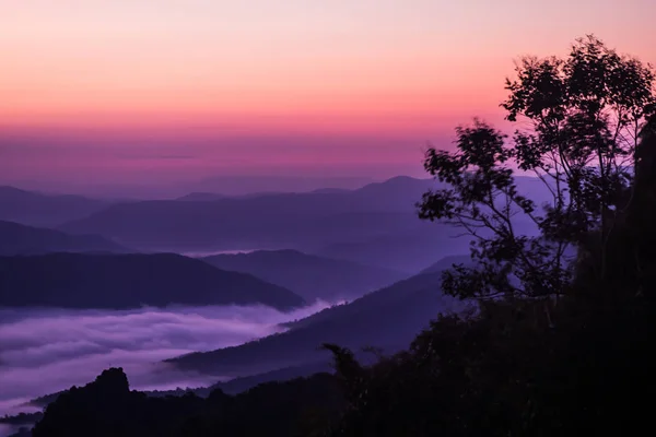 sunset overlooking mountains with Mist .