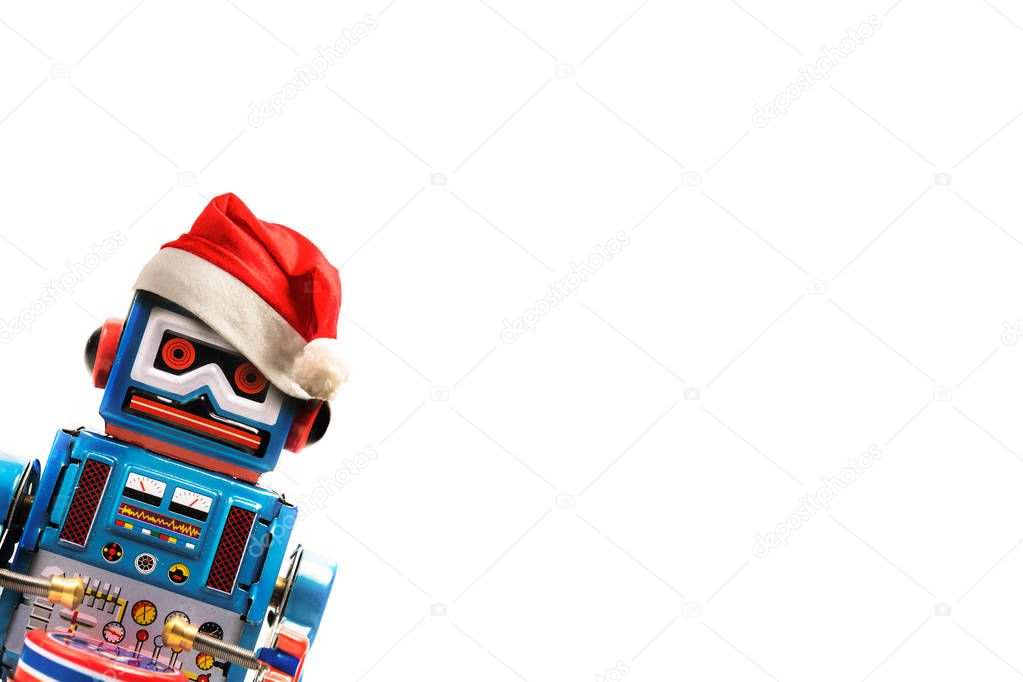 Vintage robot retro classic toy with Christmas hat on white background .