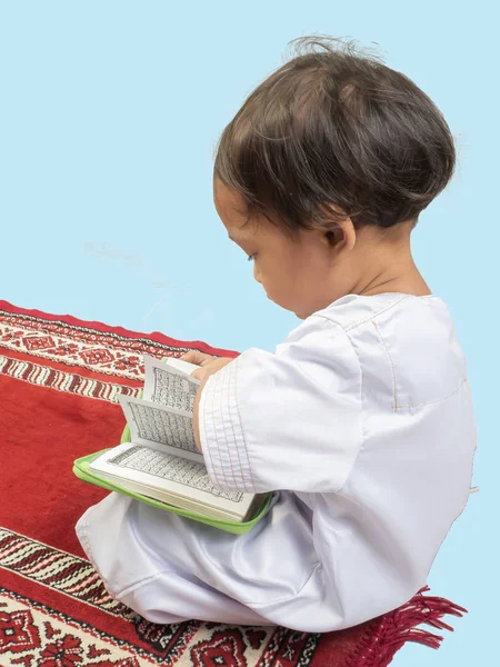Muslim boy in a dress  reading the Koran , isolate background — Stock Photo, Image