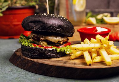 Sebze fast food, patates kızartması ve ketçap ile Siyah çikolata tava sığır peynir burger.