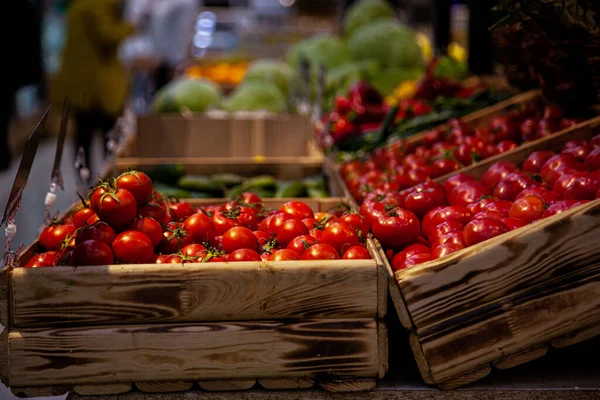 Red cherry tomatoes in wooden trays — Stock Photo, Image