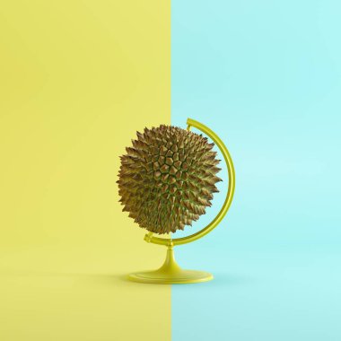 Sarı ve mavi renkli pastel arka planda Durian küresel fikir kavramı. minimal fikir kavramı.