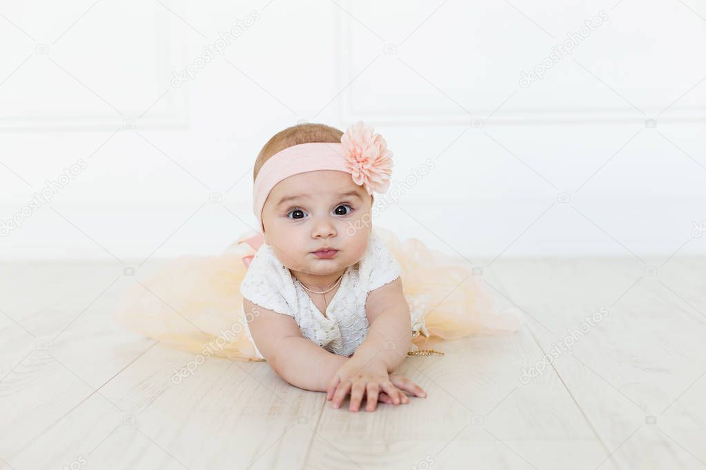 Cute baby on white background.Close up head shot of a caucasian baby girl, six months old baby