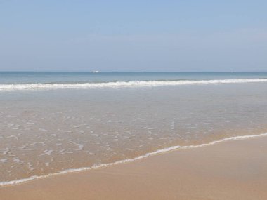 Sabah kumlu plajda sörf ve beyaz dalgalar sıçramasına