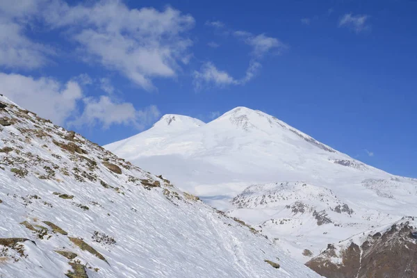 Snow at the slopes of North Caucasus and two-headed Mount Elbrus. Baksan valley, North Caucasus, Russia