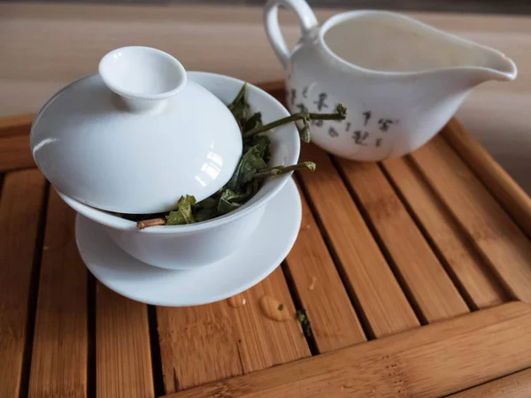 Tea brewing vessels with leaves of oolong tea on tea draining tray. Chinese traditional tea ceremony.