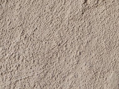 Koyu bej dokulu rendelenmiş alçı. Arka plan veya doku Dikişsiz deseni