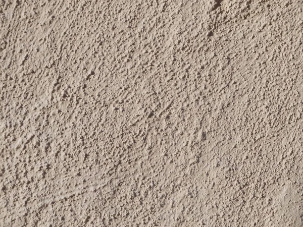 Textured grinded plaster in dark beige. Background or texture seamless pattern — Stock Photo, Image