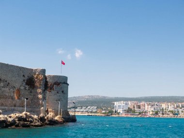 Maiden'ın kalesinin veya Kızılkale veya Deniz kalesinin tepesinde türk bayrağı ve Deniz ve Kizkalesi kasabası manzarası