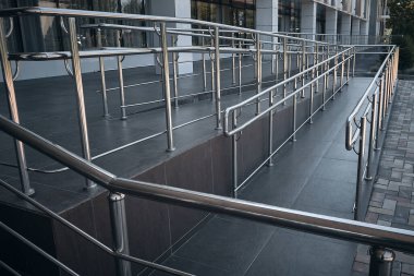 Ramp for people with disabilities and chrome railings clipart