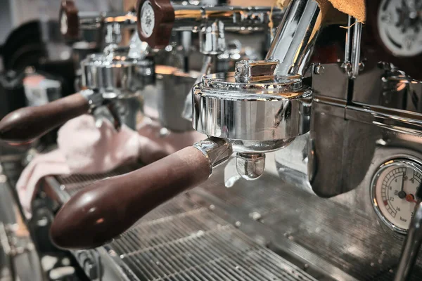 Close up of professional coffee machine. Brown handles and chrome surfaces of coffee machine.