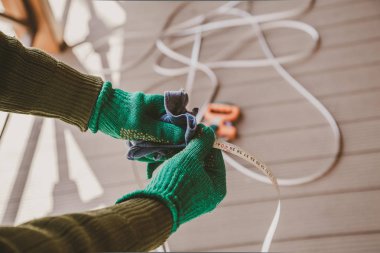 Bakım aracı. Yeşil eldiven eline bir bez metal kaset roulett ölçme uzunluğunda silin