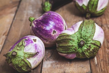 Grup bumbo eski rendelenmiş ahşap tahta üzerinde yeşil kuyruk yalanla beyaz olgun patlıcan çeşitleri