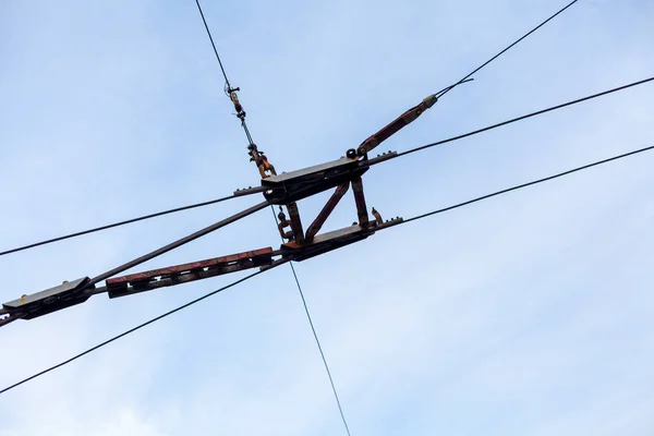 Element of electric transport. Parallel trolley and tension wire for a trolleybus against a cloudy sk
