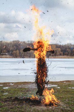 Slav tatil kış sonu. Saman büyük bir Shrovetide bebek nehir kıyısında yakar. Siyah duman görünür