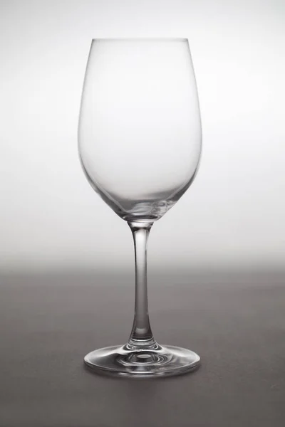 Bicchiere Vino Trasparente Vuoto Una Gamba Sta Uno Sfondo Grigio — Foto Stock