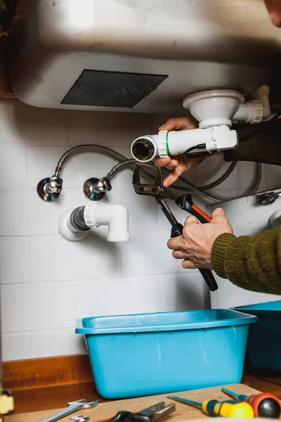 Repair of plastic system of kitchen spillway — Stock Photo, Image