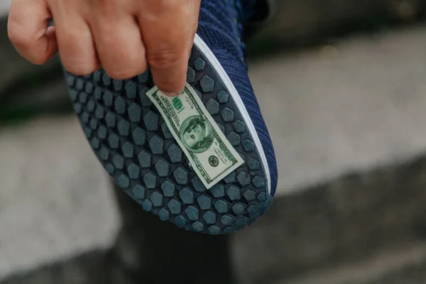 Banknote stuck to sole — Stock Photo, Image