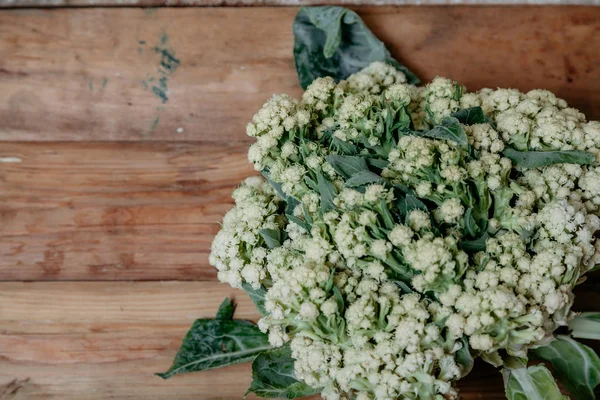 Cauliflower lies on planed boards