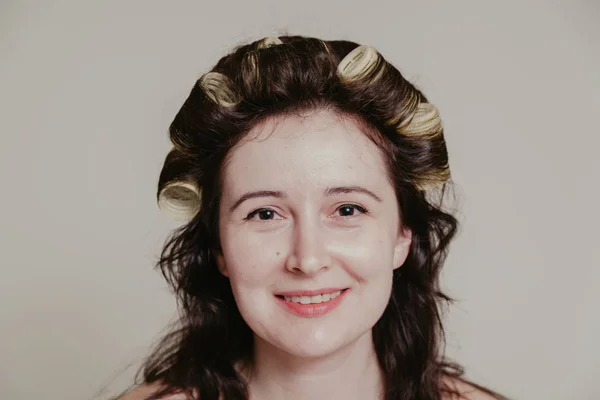 Девушка с родимым пятном на щеке с бигудями в волосах — стоковое фото
