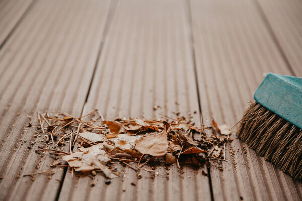 Pile of fallen leaves on floor of  veranda close up