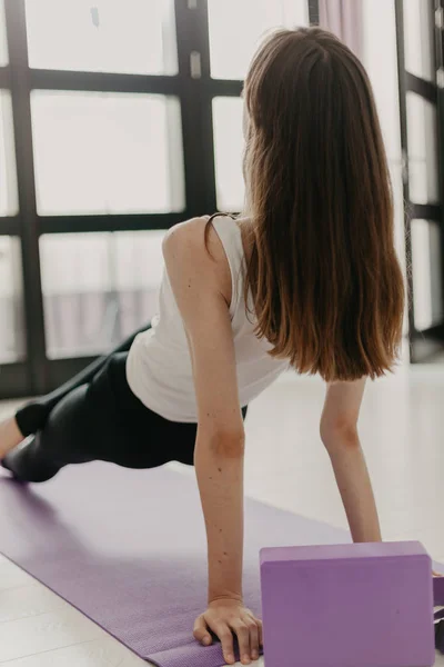 Young slender girl doing yoga