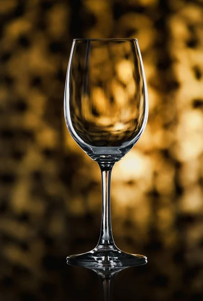 Glass wine glass stands on glass on yellow background — Stock Photo, Image