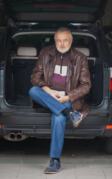 Elderly Man Leather Jacket Sits Open Trunk Car Garag — Stock Photo, Image
