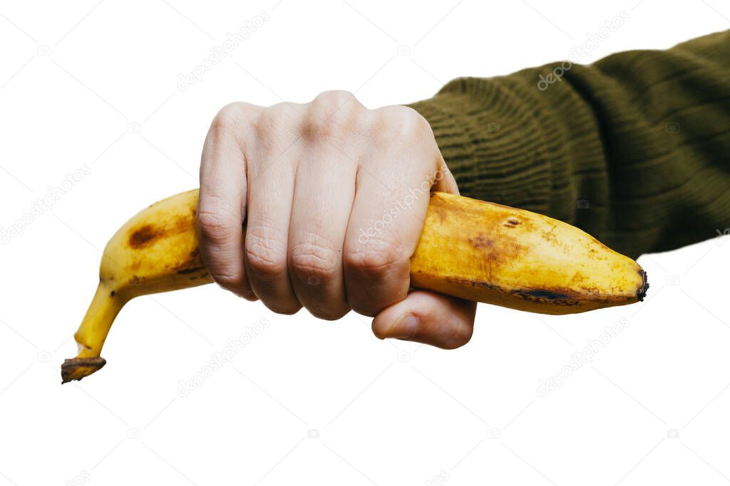 Hand man squeezes a ripe banana on a white backgroun