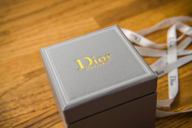 Christian Dior jewelry box after unboxing on table clipart