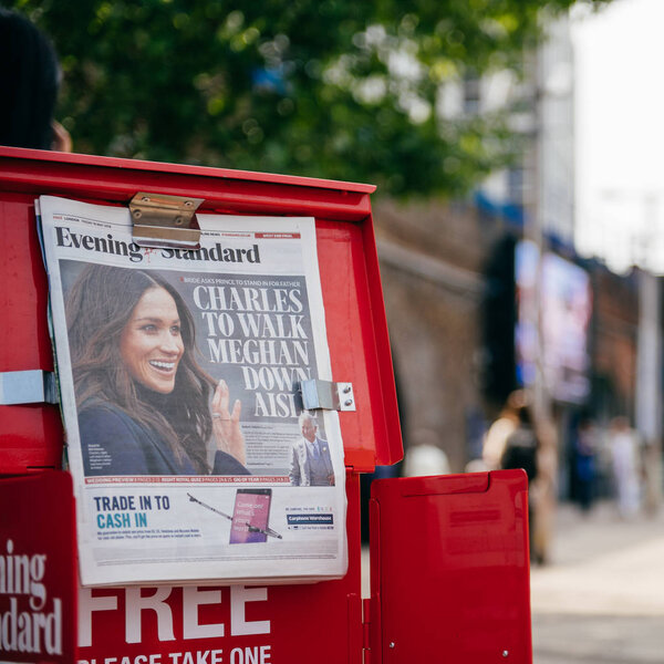 LONDON, UNITED KINGDOM - MAY 18, 2018: Close-up of newspaper cover Prince Charles to walk Meghan Markel down aisle - free media Evening Standard on London street a day before wedding 