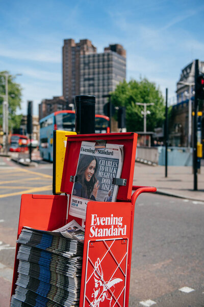 LONDON, UNITED KINGDOM - MAY 18, 2018: Prince Charles to walk Meghan Markel down aisle - cover of the free newspaper Evening Standard on London street a day before wedding - city bacjground