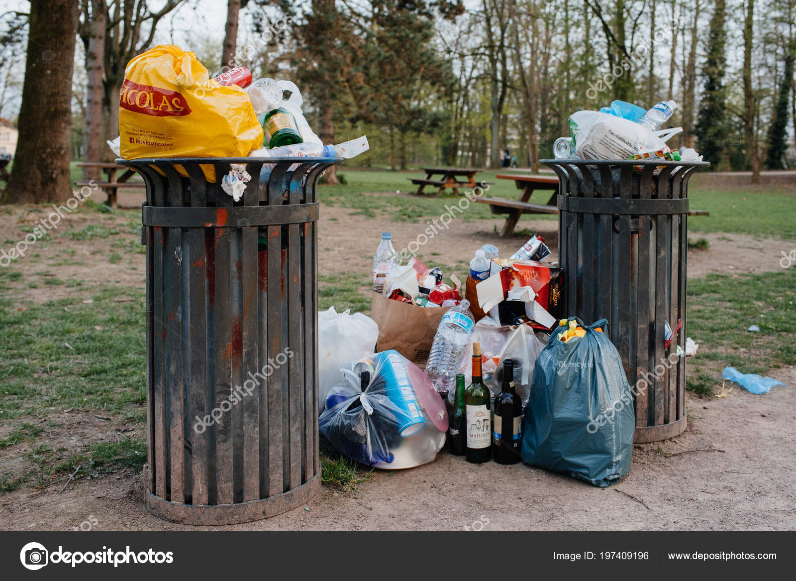 Full waste bins in a French public park Stock Editorial Photo